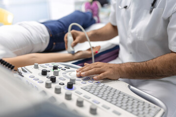 Cropped view of the male doctor holding special device while making ultrasound therapy for woman. Ultrasound of the veins of the upper xtremities concept