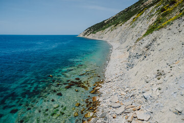 Fototapeta na wymiar Aerial view of coastline with transparent blue sea and stone beach. Summer day in Montenegro