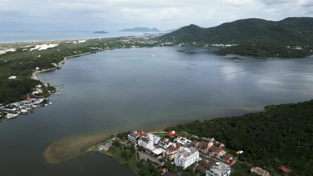 Aerial Drone Fly Above Lagoa da Conceicao, Tourist town in Santa Catarina Island Florianopolis Brazil, Natural Lagoon and Mountains Landscape