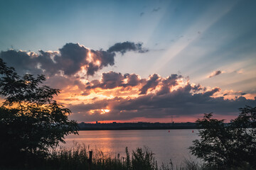 Thunderclouds gather over the road leading along the fields, creating a very magical landscape.