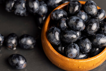 sweet ripe black grapes covered with drops of water