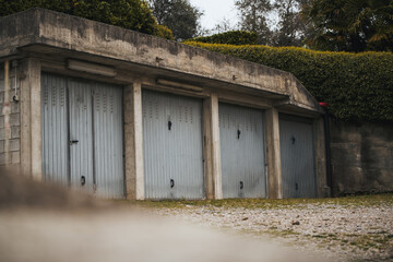 Fototapeta na wymiar Garage concept. Closed garage doors. Exterior view of a beautiful house with garage gate.