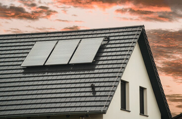 Efficient Solar Water Heating. Contemporary Pressure Collector on Rooftop. Solar water heating. Hot water from the sun. © AlexGo
