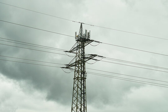 Power transmission line. Industrial background. Power pylons of an overhead line