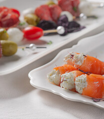 Festive table with white tablecloth and appetizers