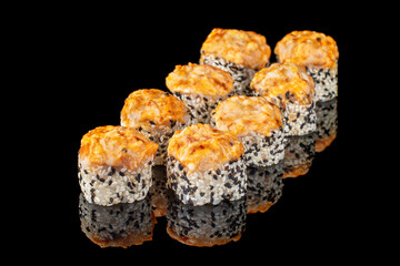 Hot sushi roll with cheese top. Baked sushi with seafood and crab, cream cheese topped on a black background with reflection. Sushi menu. Japanese food.