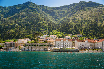 Cozy small village with old stone houses on the shore of Boka Kotor bay