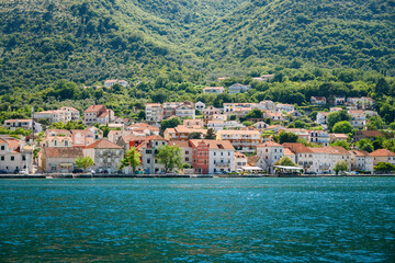 Naklejka na ściany i meble Cozy village with old stone houses on the seaside of the Bay of Kotor in Montenegro