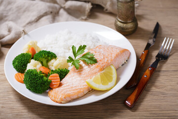 plate of  salmon fillet, rice and vegetables
