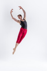 Obraz premium Male Flying Dancer. Contemporary Art Ballet With Young Flexible Athletic Man Posing in Flying Dance Pose With Hands Connected