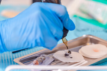 Tattoo Concept. Work Accessories and Tools for Tattoo Cosmetologist Preparing For Permanent Makeup Procedure In Beauty Salon.