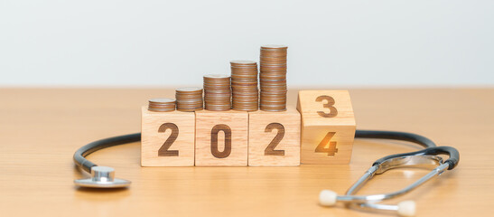 2024 Happy New Year for health care with doctor Stethoscope on table. Money saving, Goal,...