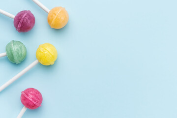 Sweet lollipops on blue background