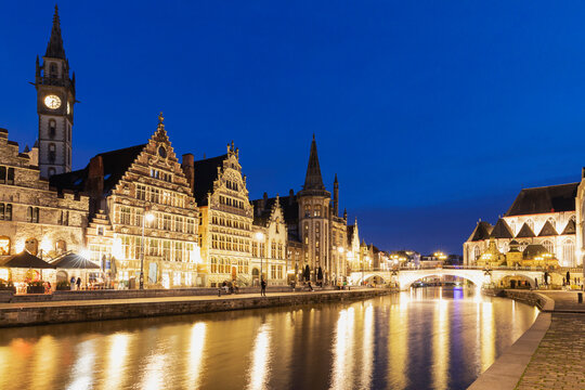 Belgium, East Flanders, Ghent, Historic houses along Graslei and Lys river at night