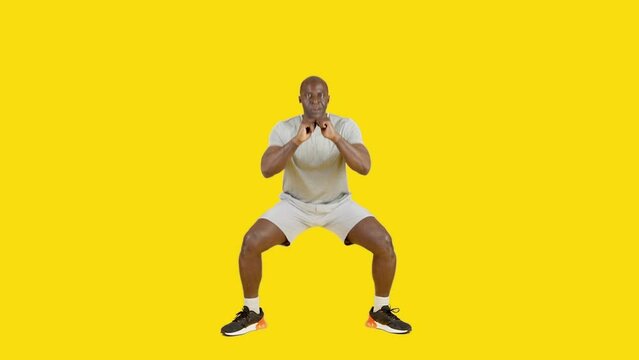 An strong african man doing sumo squats