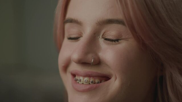 20s Woman with Dental Braces Smiling Portrait. Pretty millennial female looking at camera.