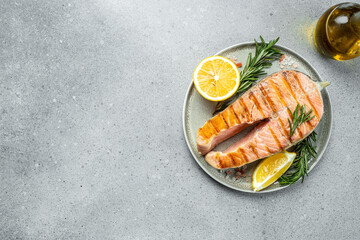 grilled salmon steak on BBQ grill coal. Keto diet concept healthy food, Long banner format. top view