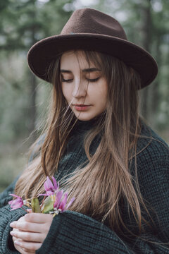 Young Woman With Long Hair Holding Flowers