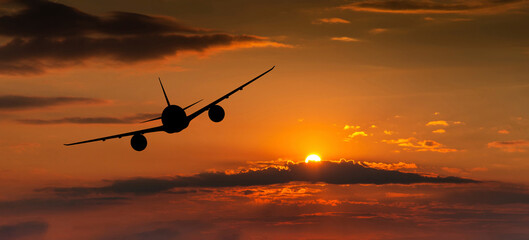 Fototapeta na wymiar Passenger plane on the background of the sunset sky