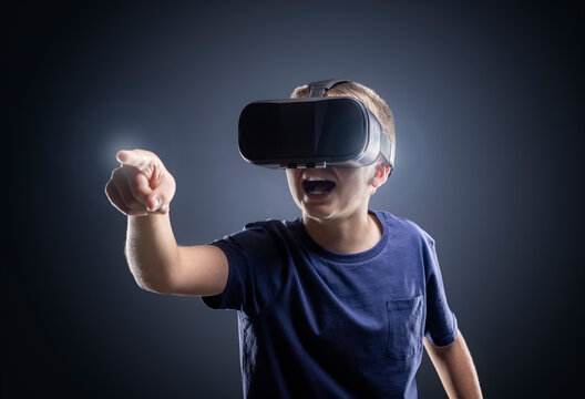 Boy experiencing using a virtual reality headset pointing