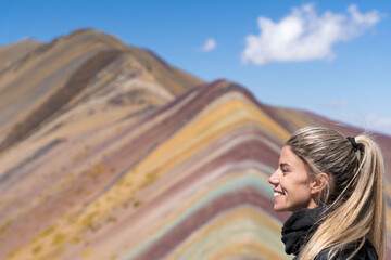 Blonde woman in landscape Rainbow Mountain or Montana Siete Colores, Cuzco, Peru