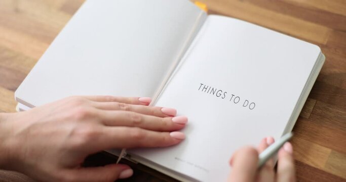 Woman writes down important things in schedule planner. Future planning plan
