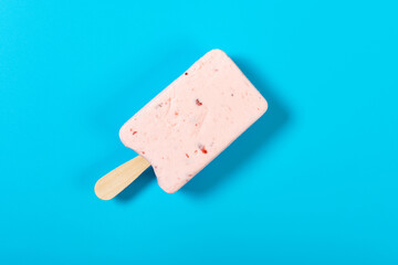 top view fresh strawberry flavor popsicle on a blue background