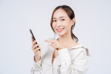 Asian women's casual outfits and natural makeup get a discount from online shopping apps on smartphones. White background. 