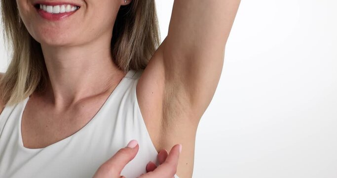Closeup of woman with clean fresh skin gently touching armpit. Female armpits without hair