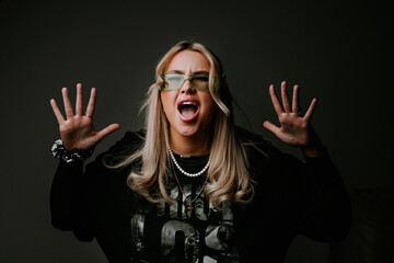 Happy blonde girl shouts yes, celebrates victory, achieves goal. Human emotions, facial expression...