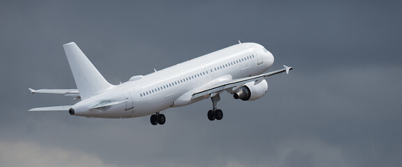 Fototapeta premium Aircraft take-off in stormy weather with black clouds in a flight and vacation issues concept