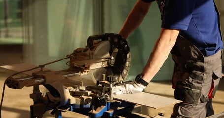 Flooring master cuts laminate board on manual circular saw. Master flooring installation