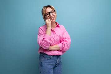 young pretty caucasian blonde secretary woman with ponytail hairstyle, glasses and in a pink shirt...