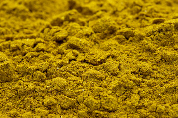 Pile of curry powder as background, spice or seasoning as background. Close-up curry powder - obrazy, fototapety, plakaty