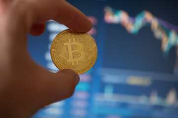 Bitcoin coin on computer background.The concept of investing in bitcoin and cryptocurrency. Cryptocurrency coins bitcoin. The dynamics of bitcoin rates. Trading on the cryptocurrency exchange. 