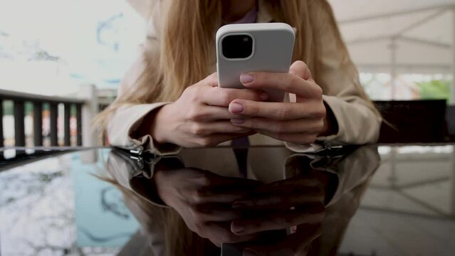 girl woman smoking hookah in terrace restaurant sitting with coffee cup on table,typing message on phone.female with cold sore herpes hpv virus on lips 4k.hookan man putting coal cubes on tabaco bowl