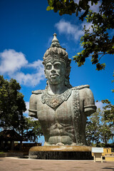 Fototapeta na wymiar A large copper statue of Wisnu's torso and head at the GWK Cultural Park in Bali, Indonesia