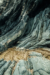 Shale cliff rock curves in gray, blue tones.