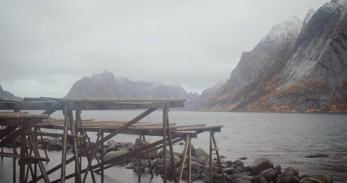 Empty racks to dry cod fish at Reine village, Lofoten, Norway on cloudy day