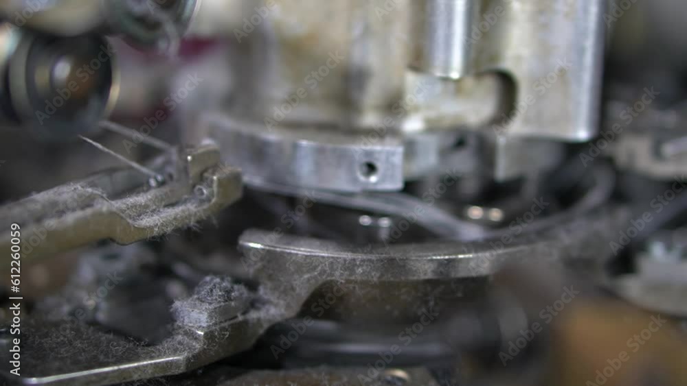 Poster close-up parts of the machine with threads, the production process in a garment factory, automated p