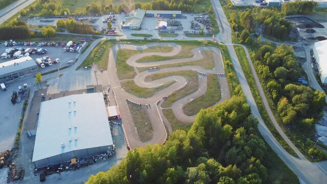Empty go kart track on a sunny evening. Orbiting drone shot