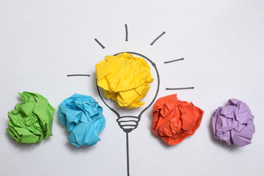 Inspiration concept crumpled color paper light bulb metaphor for good idea