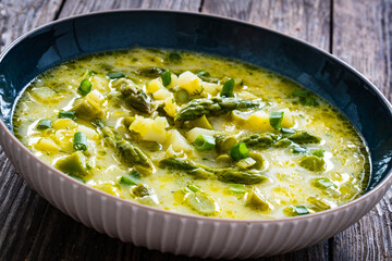 Asparagus soup on wooden table
