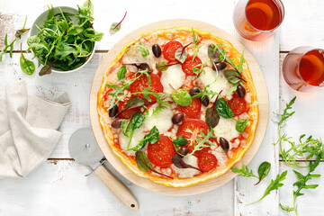 Pizza. Margherita pizza with mozzarella, tomato, olives and fresh greens. Top view