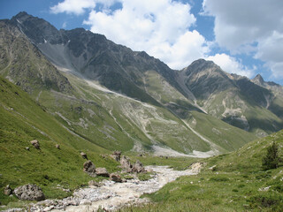 Aerial panoramic view of the Main Caucasus Mountain Ridge from Mount Elbrus, the highest summit in Europe, glacier Seven, incredible blue sky background, impressive nature landscape in North Caucasus
