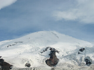 Aerial panoramic view of the Main Caucasus Mountain Ridge from Mount Elbrus, the highest summit in Europe, glacier Seven, incredible blue sky background, impressive nature landscape in North Caucasus