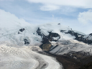 Aerial panoramic view of the Main Caucasus Mountain Ridge from Mount Elbrus, the highest summit in Europe, glacier Seven, incredible blue sky background, impressive nature landscape in North Caucasus