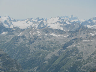 Aerial panoramic view of the Main Caucasus Mountain Ridge from Mount Elbrus, the highest summit in Europe, glacier Seven, incredible blue sky background, impressive nature landscape in North Caucasus