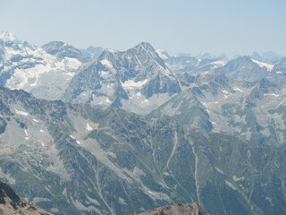 Aerial panoramic view of the Main Caucasus Mountain Ridge from Mount Elbrus, the highest summit in Europe, glacier Seven, incredible blue sky background, impressive nature landscape in North Caucasus