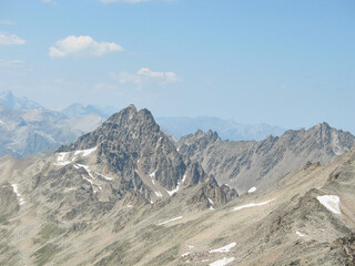 Aerial panoramic view of the Main Caucasus Mountain Ridge from Mount Elbrus, the highest summit in Europe, glacier Seven, incredible blue sky background, impressive nature landscape in North Caucasus
